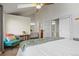 Vaulted ceiling bedroom boasts an attached bathroom, chair, and bookcase with a large bed at 1907 S Helena St # G, Aurora, CO 80013