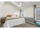 Bedroom features a vaulted ceiling, a ceiling fan, and large windows that offer ample natural light at 1907 S Helena St # G, Aurora, CO 80013