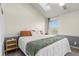 Vaulted ceiling bedroom features a comfortable queen-size bed, bedside table, and natural light at 1907 S Helena St # G, Aurora, CO 80013