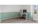 Bright bedroom features chair, desk, monitor, and wall color block, creating the perfect workspace at 1907 S Helena St # G, Aurora, CO 80013