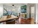 Bright dining area featuring hardwood floors, stylish wallpaper, and a contemporary wood table at 1907 S Helena St # G, Aurora, CO 80013