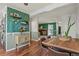 Open dining area with hardwood floors and view of the living room fireplace at 1907 S Helena St # G, Aurora, CO 80013