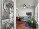 Dining area with a modern exercise bike and in-unit stacked washer/dryer at 1907 S Helena St # G, Aurora, CO 80013