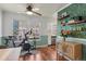 Dining area with hardwood floors, a ceiling fan, a modern exercise bike, and stylish wallpaper at 1907 S Helena St # G, Aurora, CO 80013
