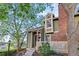 Exterior of a well-maintained townhome, accented with a brick chimney at 1907 S Helena St # G, Aurora, CO 80013