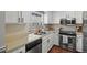 Cozy kitchen featuring stainless steel appliances and white cabinets at 1907 S Helena St # G, Aurora, CO 80013