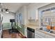 Compact kitchen with stainless steel appliances, and a peek into the dining area at 1907 S Helena St # G, Aurora, CO 80013