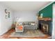 Inviting living room with hardwood floors, a comfortable sofa, a fireplace, and lots of natural light at 1907 S Helena St # G, Aurora, CO 80013