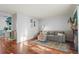 Comfortable living room featuring hardwood floors, a sectional sofa, and a cozy ambiance for relaxation at 1907 S Helena St # G, Aurora, CO 80013