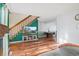 Open-concept living area featuring a staircase, hardwood floors, fireplace, and a dining area, perfect for entertaining at 1907 S Helena St # G, Aurora, CO 80013
