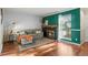 Bright living room boasts hardwood floors, a fireplace, a large window, and a cozy seating area for entertainment at 1907 S Helena St # G, Aurora, CO 80013