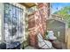 Outdoor patio features charming chairs, brick detail, and a grill for entertaining at 1907 S Helena St # G, Aurora, CO 80013