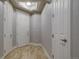 Bright hallway with light wood floors and doors at 1735 N Ogden St # 303, Denver, CO 80218