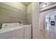 Laundry room with washer, dryer, and additional shelving at 1735 N Ogden St # 303, Denver, CO 80218