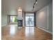 Bright living room with fireplace and hardwood floors, leading to a private balcony at 1735 N Ogden St # 303, Denver, CO 80218