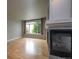 Living room with hardwood floors, fireplace, and large window at 1735 N Ogden St # 303, Denver, CO 80218