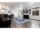 Spacious finished basement has a cozy sitting area and a large TV for entertainment at 11823 Barrentine Loop, Parker, CO 80138