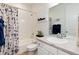 Bright bathroom features a shower-tub combination, white vanity, and decorative accents at 11823 Barrentine Loop, Parker, CO 80138