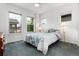 Comfortable bedroom features multiple windows, a patterned bed, and warm lighting at 11823 Barrentine Loop, Parker, CO 80138