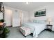 View of comfortable bedroom including bed with floral patterns and decorated ottoman at 11823 Barrentine Loop, Parker, CO 80138