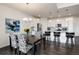 Bright dining area features stylish chairs, a modern chandelier, and an open floor plan leading to the kitchen at 11823 Barrentine Loop, Parker, CO 80138