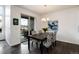 Dining area with table and chairs, sliding glass door to patio, and modern chandelier at 11823 Barrentine Loop, Parker, CO 80138