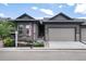 Charming home featuring a two-car garage, stone accents, beautiful landscaping and an American flag at 11823 Barrentine Loop, Parker, CO 80138