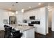Bright kitchen boasts white cabinets, stainless steel appliances, and granite countertops at 11823 Barrentine Loop, Parker, CO 80138