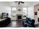 Spacious living room features fireplace, large windows, and an entertainment center with a large screen tv at 11823 Barrentine Loop, Parker, CO 80138