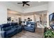 Open concept living room with adjacent dining and kitchen and a staircase to the second story at 11823 Barrentine Loop, Parker, CO 80138
