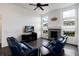 Enjoy the comforts of this living room with fireplace, large windows, and leather sofas at 11823 Barrentine Loop, Parker, CO 80138