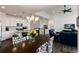 Open-concept living space featuring a kitchen, dining area, and living room with high ceilings at 11823 Barrentine Loop, Parker, CO 80138