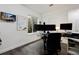 A well-lit office features a desk area, and a wall mounted white board and TV at 11823 Barrentine Loop, Parker, CO 80138