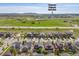 Aerial view of a neighborhood near a golf course with suburban homes and green spaces at 525 Grenville Cir, Erie, CO 80516