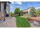 Grassy backyard featuring a stone pathway, lawn, privacy fence, and landscaped yard at 525 Grenville Cir, Erie, CO 80516