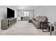 Entertainer's basement featuring a large screen TV, a wet bar, and a comfortable sectional sofa at 525 Grenville Cir, Erie, CO 80516