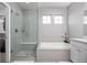 Stylish bathroom featuring a glass-enclosed shower, soaking tub, and modern fixtures at 525 Grenville Cir, Erie, CO 80516