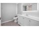 Bright bathroom with a large, lighted mirror, and a shower with tiled walls at 525 Grenville Cir, Erie, CO 80516