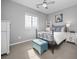Bright bedroom with an iron bed frame, a window with natural light, and unique accents at 525 Grenville Cir, Erie, CO 80516