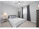 Cozy bedroom with a ceiling fan, a grey bed, and black out curtains at 525 Grenville Cir, Erie, CO 80516
