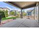 Covered patio with decorative stone pillars, concrete flooring, and a lovely yard at 525 Grenville Cir, Erie, CO 80516