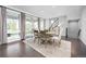 Elegant dining room with hardwood floors, large windows, and a stylish light fixture at 525 Grenville Cir, Erie, CO 80516