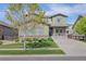 Charming two-story home featuring stone accents, an attached garage, and a cozy front porch at 525 Grenville Cir, Erie, CO 80516