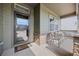 Inviting front porch with seating area, stone accents, and a clear view of the neighborhood at 525 Grenville Cir, Erie, CO 80516