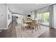 Open-concept kitchen and dining area with hardwood floors and stainless steel appliances at 525 Grenville Cir, Erie, CO 80516
