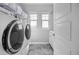 Functional laundry room with modern washer and dryer, ample storage, and natural light at 525 Grenville Cir, Erie, CO 80516