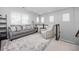 Upstairs living room with grey sofa and plush chair at 525 Grenville Cir, Erie, CO 80516