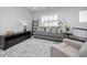 Upstairs living room with grey sofa and plush chair at 525 Grenville Cir, Erie, CO 80516