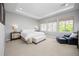 Spacious main bedroom boasts a tray ceiling, large windows, carpeted floors, and sitting area at 525 Grenville Cir, Erie, CO 80516