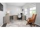 Well-lit home office with custom built-ins, hardwood floors, and large windows at 525 Grenville Cir, Erie, CO 80516